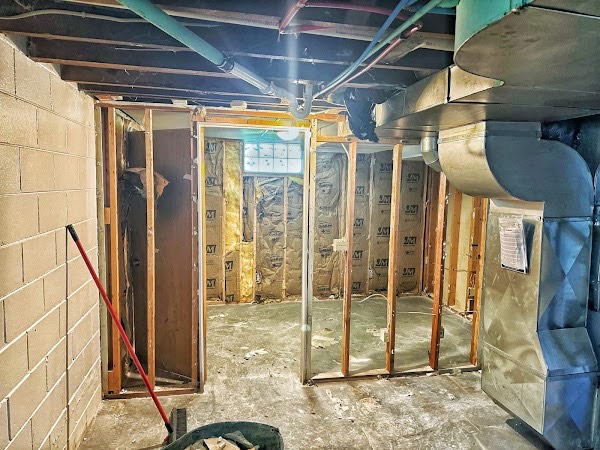 Pizza Hut work area cleared of debris, with wall framing and mechanical equipment remaining