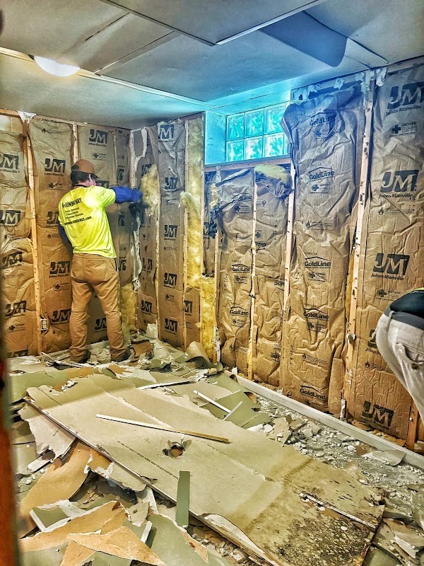 JunkAway worker removing interior wall finishes at the Manitowoc Pizza Hut project